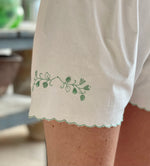 Load image into Gallery viewer, Vintage shorts lined with embroidered flowers.
